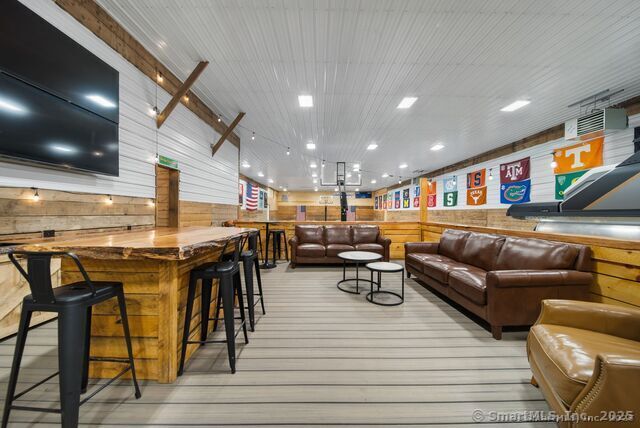 879 Russell Ave, Suffield, CT 06078 - living area featuring wood walls and light wood-style floors