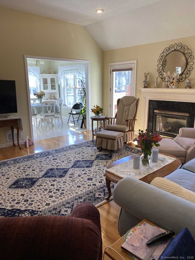 45 Kuhr Dr, Southington, CT 06489 - living area featuring lofted ceiling, wood finished floors, and a fireplace