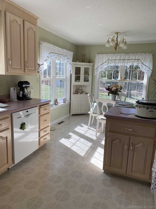 45 Kuhr Dr, Southington, CT 06489 - kitchen featuring white dishwasher, a chandelier, a textured ceiling, light floors, and dark countertops