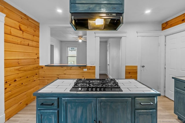 593 Cooke St, Waterbury, CT 06710 - kitchen with tile counters, light wood-style floors, black gas cooktop, ceiling fan, and ornamental molding