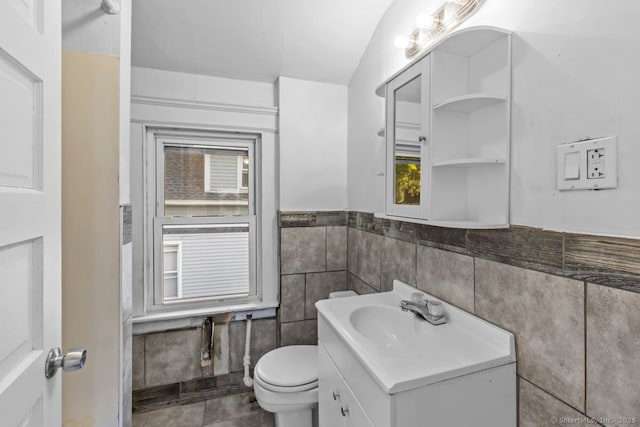 593 Cooke St, Waterbury, CT 06710 - bathroom featuring tile walls, vanity, toilet, and a wainscoted wall