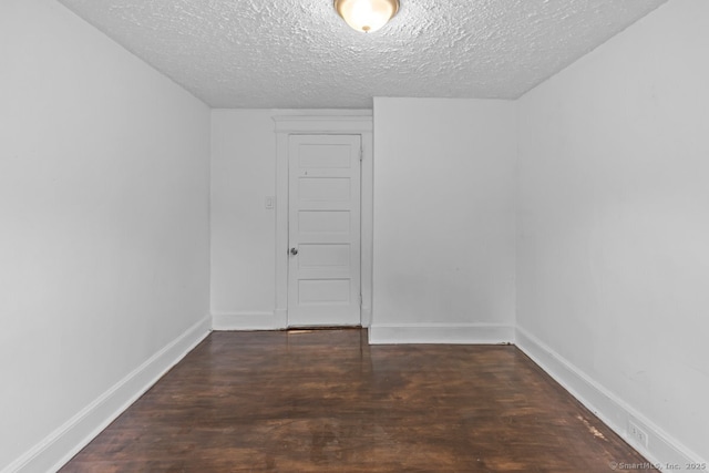 593 Cooke St, Waterbury, CT 06710 - empty room with wood finished floors, a textured ceiling, and baseboards