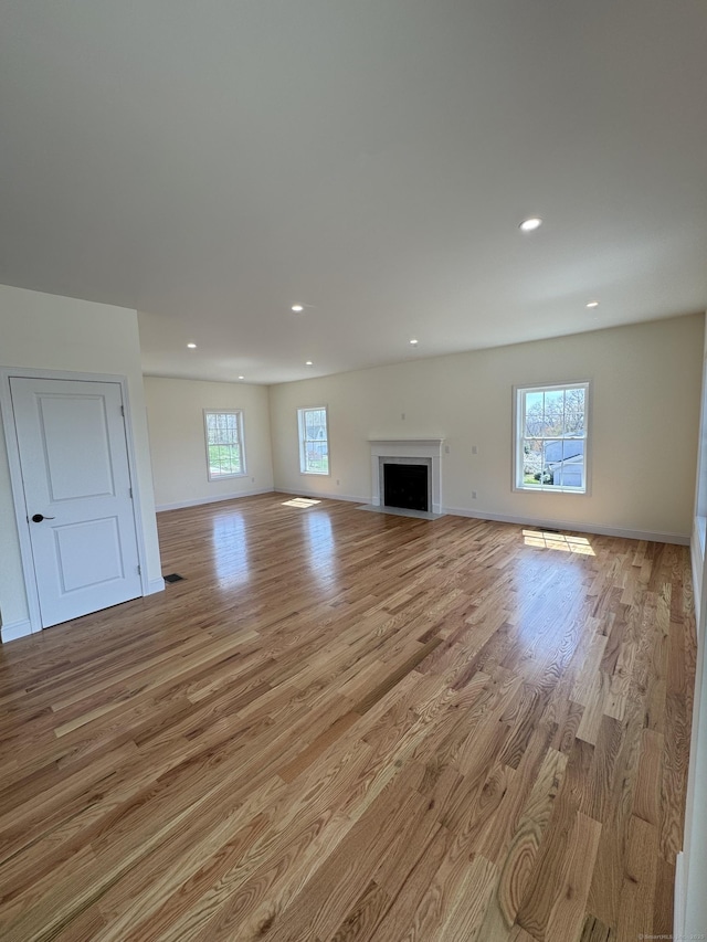 490 Lazy Ln, Southington, CT 06489 - unfurnished living room with light wood-type flooring, recessed lighting, baseboards, and a fireplace