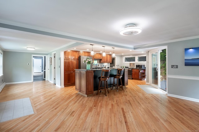 27 Pleasant Valley Rd, Barkhamsted, CT 06063 - kitchen with appliances with stainless steel finishes, light wood finished floors, a breakfast bar, brown cabinetry, and a kitchen island