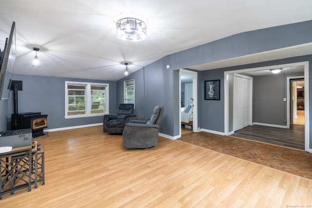 27 Pleasant Valley Rd, Barkhamsted, CT 06063 - living room featuring wood finished floors, a wood stove, lofted ceiling, and baseboards