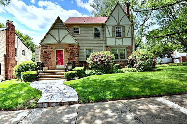 166 Roydon Rd, New Haven, CT 06511 - tudor house with brick siding, a front lawn, and a chimney