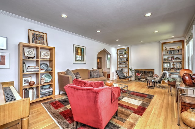 166 Roydon Rd, New Haven, CT 06511 - living room with arched walkways, a glass covered fireplace, hardwood / wood-style floors, recessed lighting, and crown molding