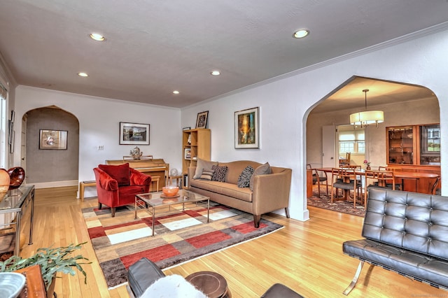 166 Roydon Rd, New Haven, CT 06511 - living area with arched walkways, ornamental molding, light wood-type flooring, and recessed lighting