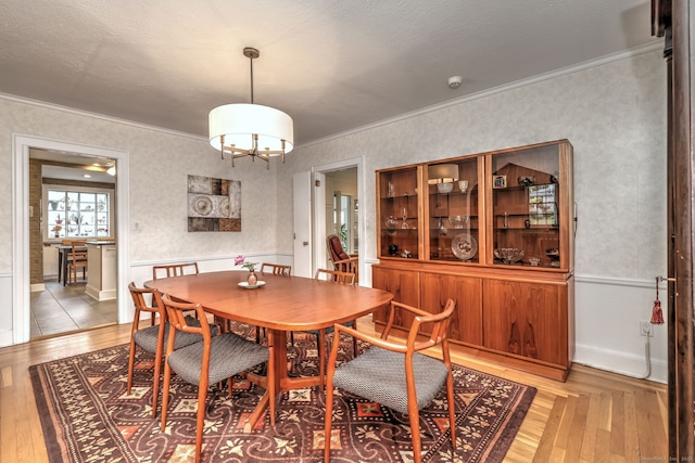 166 Roydon Rd, New Haven, CT 06511 - dining room with a chandelier, ornamental molding, light wood-type flooring, and wallpapered walls