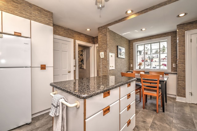166 Roydon Rd, New Haven, CT 06511 - kitchen with freestanding refrigerator, recessed lighting, dark stone counters, and a kitchen island