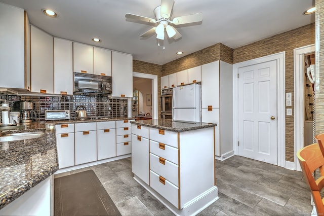 166 Roydon Rd, New Haven, CT 06511 - kitchen with black microwave, a ceiling fan, freestanding refrigerator, stainless steel gas stovetop, and white cabinetry