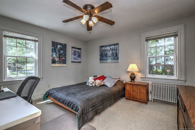 166 Roydon Rd, New Haven, CT 06511 - bedroom featuring radiator heating unit, multiple windows, light carpet, a ceiling fan, and a textured ceiling