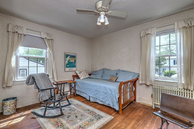 166 Roydon Rd, New Haven, CT 06511 - bedroom with radiator heating unit, hardwood / wood-style floors, wallpapered walls, and a ceiling fan