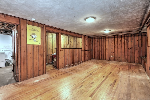 166 Roydon Rd, New Haven, CT 06511 - unfurnished room featuring hardwood / wood-style floors, washer / dryer, wooden walls, and a smoke detector