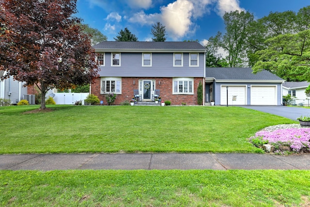 25 Bittersweet Ln, Berlin, CT 06037 - colonial-style house with an attached garage, driveway, and brick siding