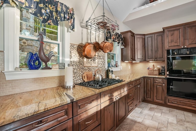 1 Shady Knls, Danbury, CT 06811 - kitchen with decorative backsplash, lofted ceiling, gas stovetop, light stone counters, and stone finish flooring
