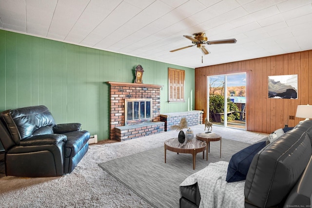 75 W Shore Rd, Ellington, CT 06029 - carpeted living room featuring a ceiling fan, a brick fireplace, baseboard heating, and wooden walls