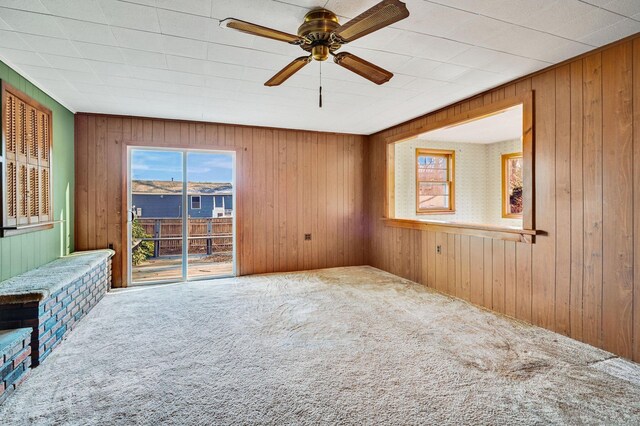 75 W Shore Rd, Ellington, CT 06029 - empty room with carpet floors, wood walls, and ceiling fan