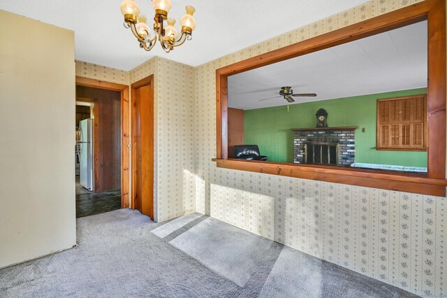 75 W Shore Rd, Ellington, CT 06029 - kitchen featuring freestanding refrigerator, a chandelier, a ceiling fan, carpet, and a fireplace