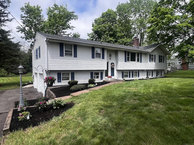 405 Williams Rd, Wallingford, CT 06492 - bi-level home with a chimney, an attached garage, driveway, and a front lawn