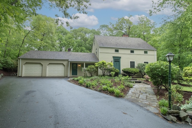 82 Whitethorn Dr, Guilford, CT 06437 - colonial-style house featuring a chimney, an attached garage, driveway, and a shingled roof