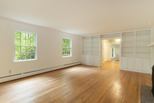 82 Whitethorn Dr, Guilford, CT 06437 - empty room featuring a baseboard heating unit, light wood-style flooring, ornamental molding, and built in features