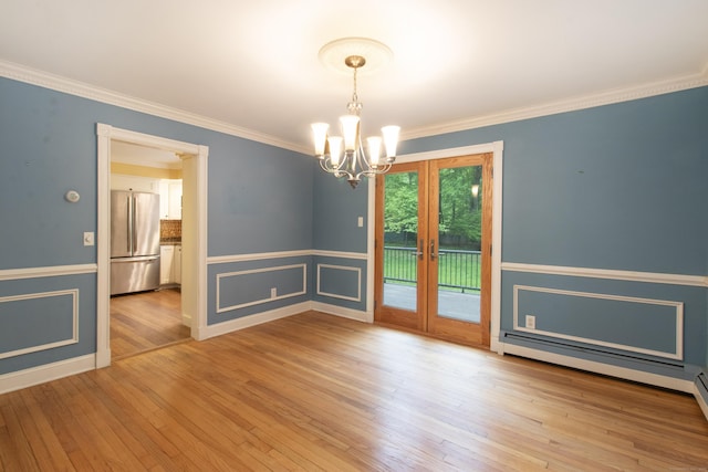 82 Whitethorn Dr, Guilford, CT 06437 - spare room featuring a chandelier, french doors, crown molding, wainscoting, and light wood finished floors