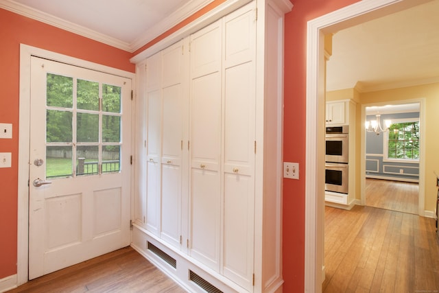 82 Whitethorn Dr, Guilford, CT 06437 - interior space featuring light wood-type flooring, a chandelier, ornamental molding, healthy amount of natural light, and baseboards