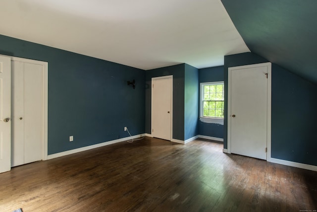 82 Whitethorn Dr, Guilford, CT 06437 - unfurnished bedroom with wood finished floors, vaulted ceiling, and baseboards