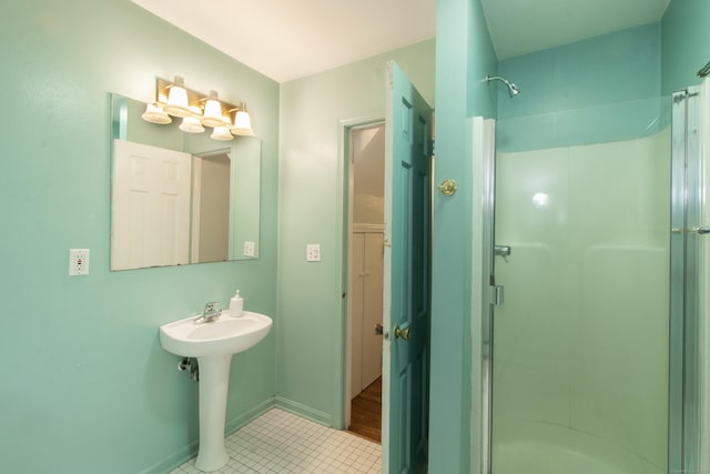 82 Whitethorn Dr, Guilford, CT 06437 - bathroom with a stall shower, tile patterned flooring, baseboards, and a sink