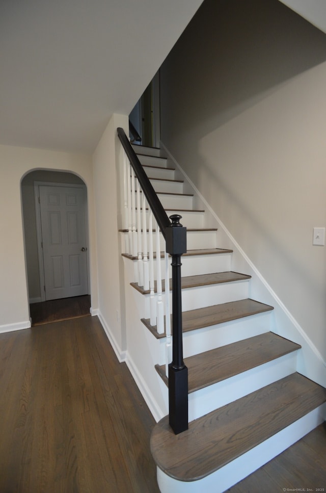 14 Harvest Ln, Bristol, CT 06010 - stairway featuring wood finished floors, arched walkways, and baseboards
