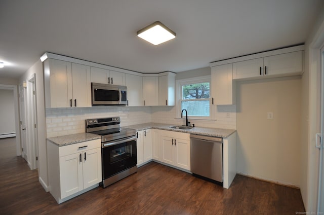 14 Harvest Ln, Bristol, CT 06010 - kitchen with stainless steel appliances, a sink, dark wood-type flooring, tasteful backsplash, and white cabinetry