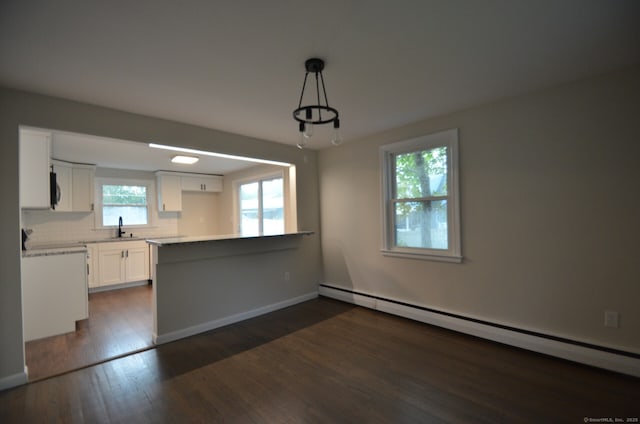 14 Harvest Ln, Bristol, CT 06010 - kitchen with baseboard heating, white cabinetry, a peninsula, a sink, and dark wood-style floors