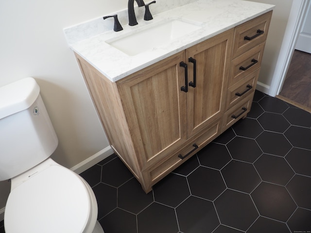 14 Harvest Ln, Bristol, CT 06010 - bathroom featuring toilet, vanity, and baseboards