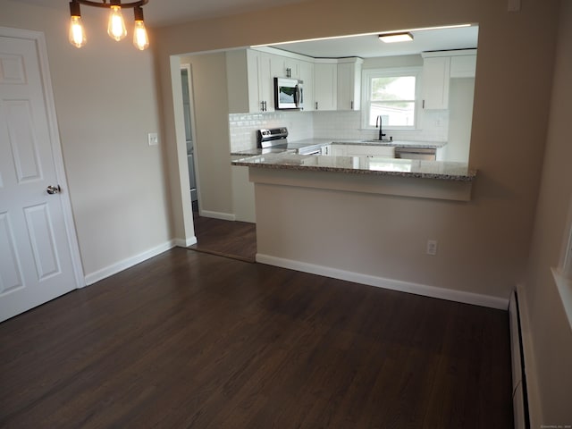 14 Harvest Ln, Bristol, CT 06010 - kitchen with stainless steel appliances, tasteful backsplash, dark wood-style flooring, and white cabinetry