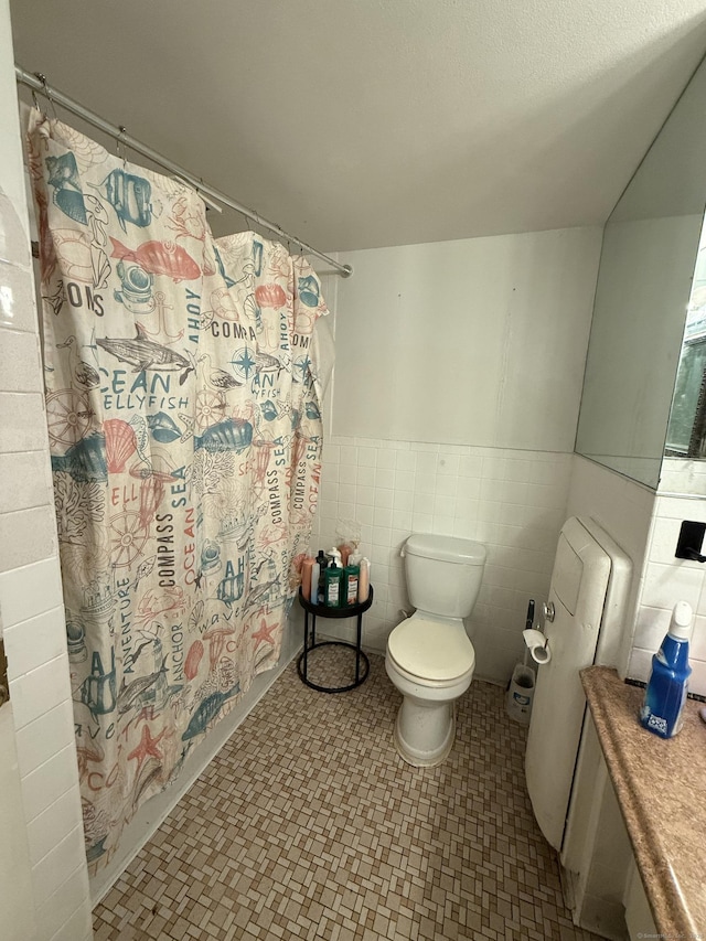 30 Woodland St Apt 5F, Hartford, CT 06105 - full bathroom featuring toilet, a shower with shower curtain, a wainscoted wall, and tile patterned floors