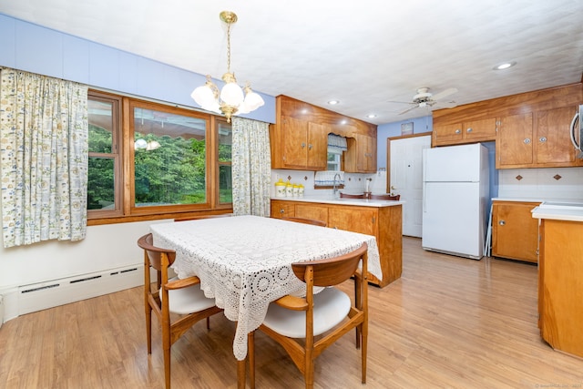 dining space with baseboard heating, light wood-style floors, a ceiling fan, a chandelier, and recessed lighting