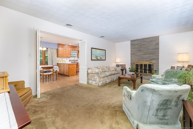 living room with light carpet and a fireplace