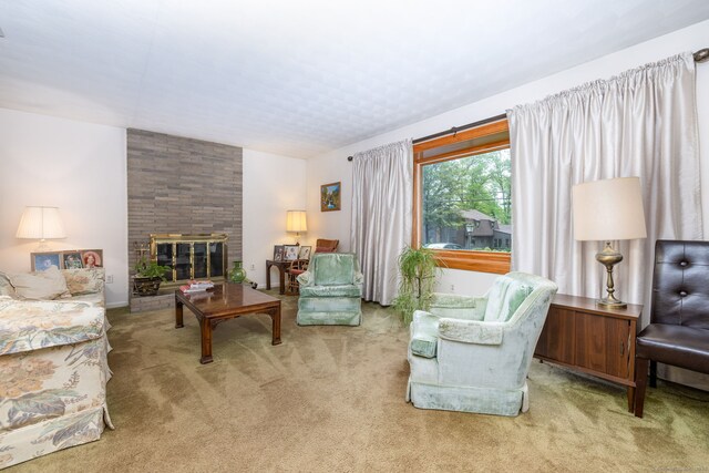 carpeted living room featuring a large fireplace