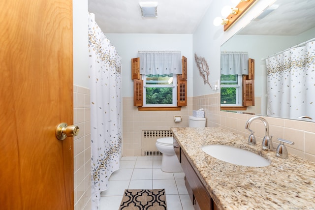 bathroom featuring radiator heating unit, tile patterned flooring, tile walls, toilet, and vanity