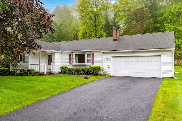 ranch-style house featuring asphalt driveway, a chimney, an attached garage, a front lawn, and covered porch
