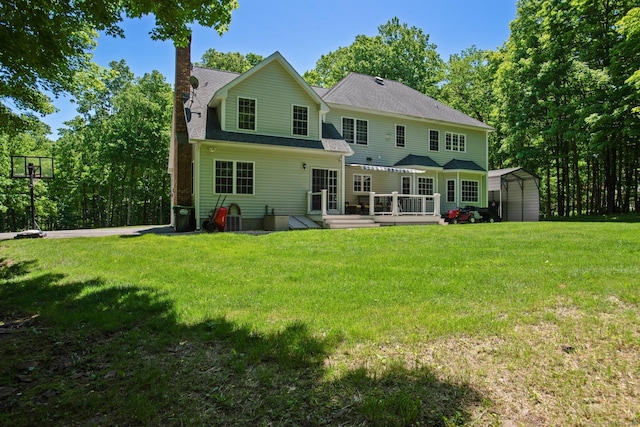 81 Red Barns Rd, Guilford, CT 06437 - back of house featuring a wooden deck, a chimney, a carport, a lawn, and a shingled roof