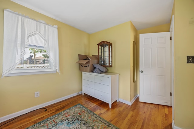 bedroom with wood finished floors and baseboards