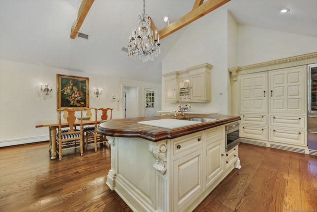 33 Carrington Dr, Stamford, CT 06831 - kitchen featuring cream cabinets, stainless steel microwave, a chandelier, beamed ceiling, and high vaulted ceiling