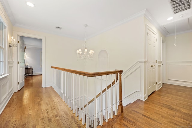 33 Carrington Dr, Stamford, CT 06831 - hall with a decorative wall, attic access, light wood-style flooring, a chandelier, and an upstairs landing