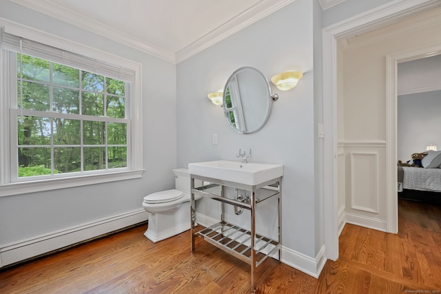 33 Carrington Dr, Stamford, CT 06831 - bathroom with a baseboard heating unit, wood finished floors, crown molding, and connected bathroom