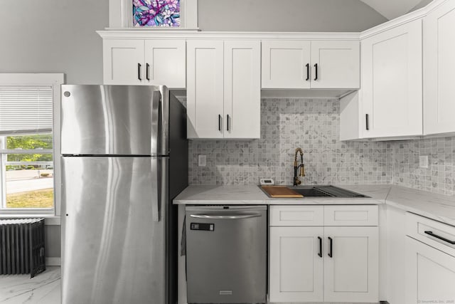 182 Rte 66, Columbia, CT 06237 - kitchen with appliances with stainless steel finishes, radiator, a sink, white cabinetry, and lofted ceiling
