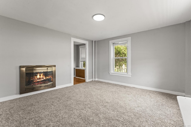 182 Rte 66, Columbia, CT 06237 - unfurnished living room featuring carpet flooring, a glass covered fireplace, and baseboards
