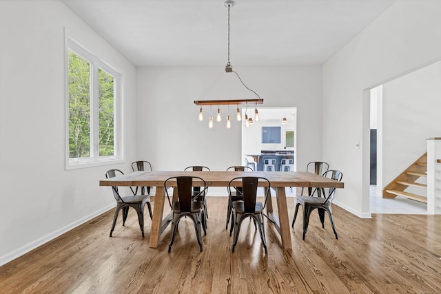 20A Bush Hill Dr, East Lyme, CT 06357 - dining room featuring stairs, wood finished floors, and baseboards
