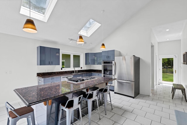 20A Bush Hill Dr, East Lyme, CT 06357 - kitchen featuring appliances with stainless steel finishes, a skylight, a sink, a breakfast bar, and blue cabinetry